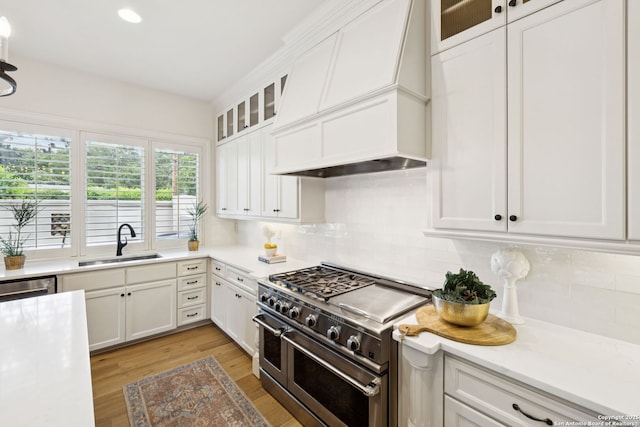 172 Katherine Ct Unit 1, San Antonio, TX 78209 - kitchen featuring stainless steel appliances, custom range hood, a sink, tasteful backsplash, and white cabinetry