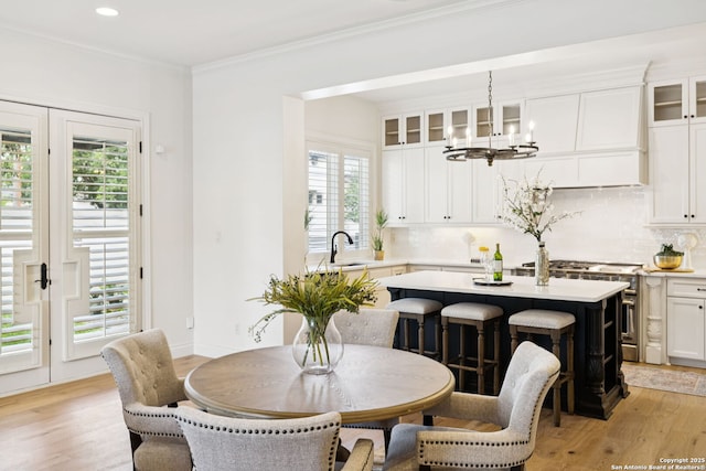 172 Katherine Ct Unit 1, San Antonio, TX 78209 - dining space with a chandelier, light wood-type flooring, recessed lighting, and crown molding