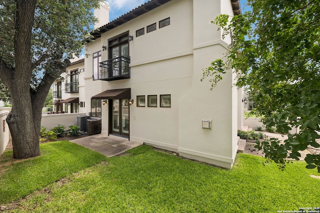 172 Katherine Ct Unit 1, San Antonio, TX 78209 - back of property with a balcony, french doors, a chimney, a yard, and stucco siding