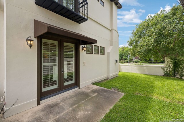 172 Katherine Ct Unit 1, San Antonio, TX 78209 - doorway to property featuring french doors, a lawn, a balcony, and stucco siding