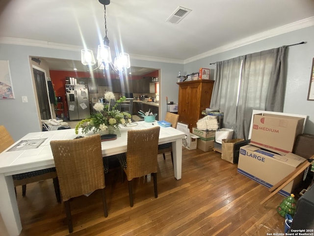 1202 Pine, Orange, TX 77630 - dining room with a chandelier, crown molding, and hardwood / wood-style flooring