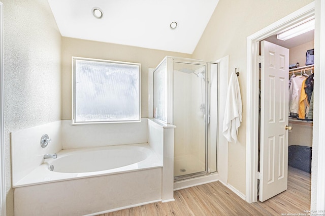 132 Las Palomas Ln, Vernia, TX 78121 - full bathroom with a stall shower, wood finished floors, a bath, and a walk in closet