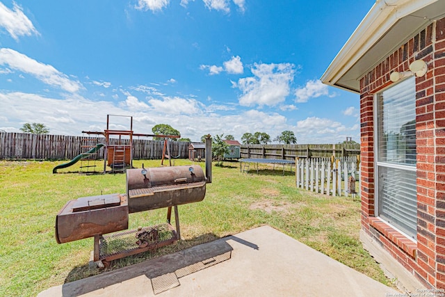 132 Las Palomas Ln, Vernia, TX 78121 - view of yard featuring a playground, a trampoline, and a patio area