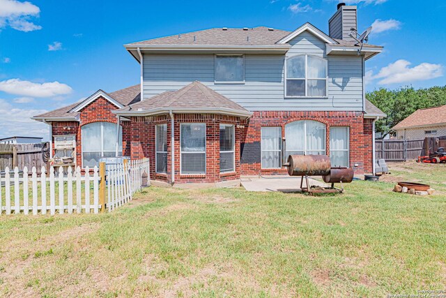 132 Las Palomas Ln, Vernia, TX 78121 - rear view of house with brick siding, a patio area, a chimney, and roof with shingles