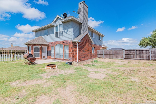 132 Las Palomas Ln, Vernia, TX 78121 - back of house featuring an outdoor fire pit, brick siding, a patio area, and a chimney