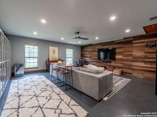 120 Spanish Oak Trl, Floresville, TX 78114 - living room with wood walls, recessed lighting, a ceiling fan, finished concrete floors, and baseboards