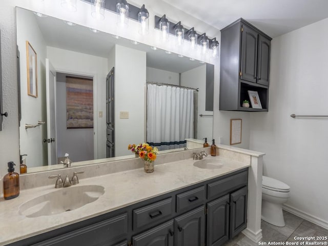120 Spanish Oak Trl, Floresville, TX 78114 - bathroom with toilet, double vanity, baseboards, and tile patterned flooring