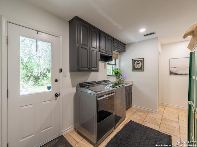 120 Spanish Oak Trl, Floresville, TX 78114 - laundry room with washing machine and clothes dryer, cabinet space, baseboards, stone tile floors, and recessed lighting