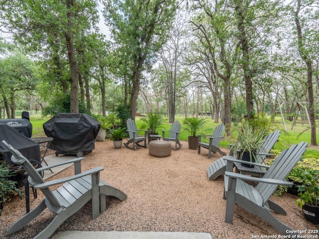 120 Spanish Oak Trl, Floresville, TX 78114 - surrounding community with a fire pit and view of scattered trees