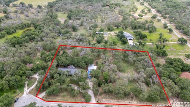 120 Spanish Oak Trl, Floresville, TX 78114 - aerial view of property and surrounding area featuring property parcel outlined and a forest