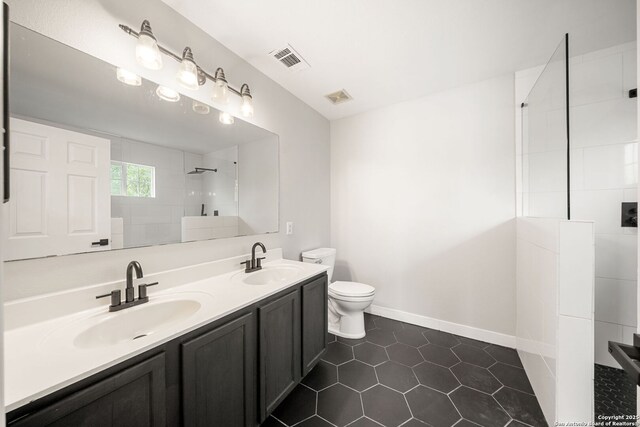 11907 Creek Peak, San Antonio, TX 78253 - bathroom featuring toilet, walk in shower, double vanity, tile patterned flooring, and baseboards