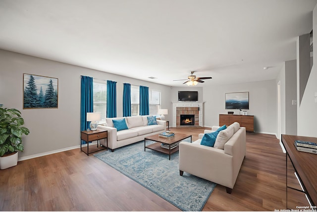 11907 Creek Peak, San Antonio, TX 78253 - living area featuring ceiling fan, a tile fireplace, wood finished floors, and baseboards
