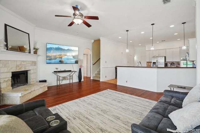 7027 Laura Hts, Schertz, TX 78154 - living area featuring ceiling fan, wood finished floors, stairs, recessed lighting, and crown molding