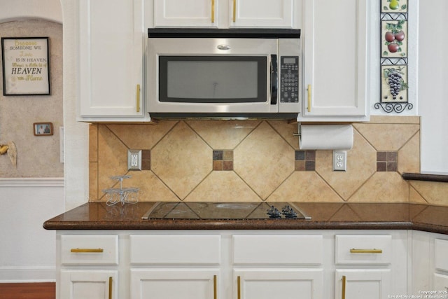 7027 Laura Hts, Schertz, TX 78154 - kitchen with stainless steel microwave, black electric stovetop, white cabinetry, and baseboards