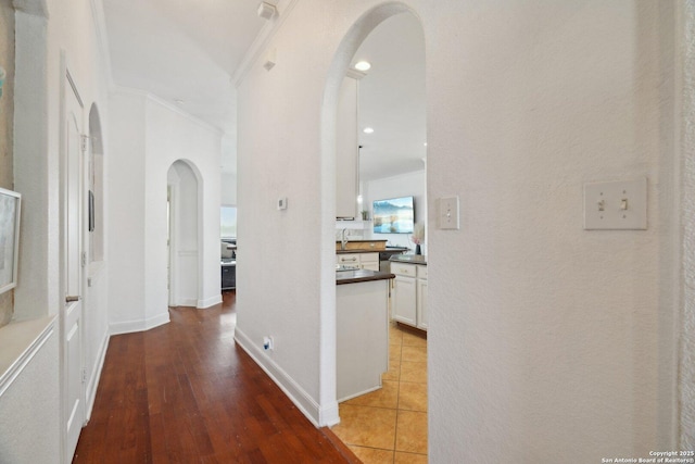7027 Laura Hts, Schertz, TX 78154 - hall with arched walkways, ornamental molding, and light wood finished floors
