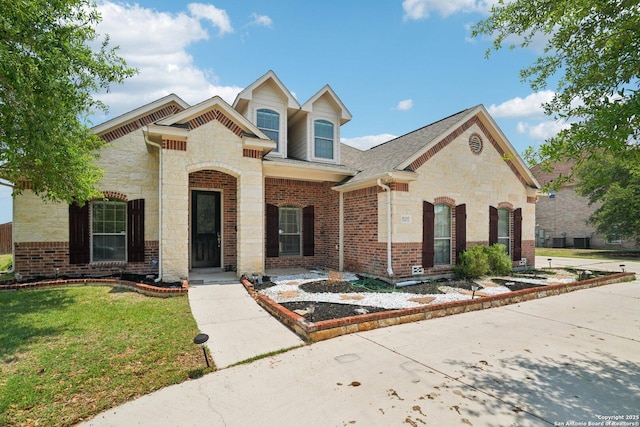 7027 Laura Hts, Schertz, TX 78154 - view of front facade with stone siding, a front yard, and brick siding