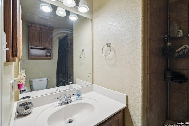 7027 Laura Hts, Schertz, TX 78154 - full bath featuring toilet, a textured wall, and vanity