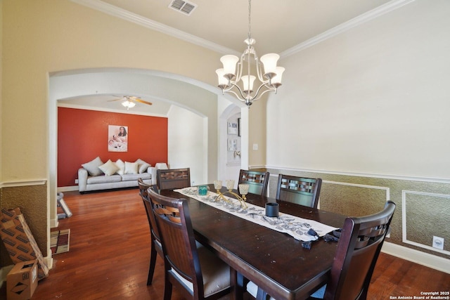 7027 Laura Hts, Schertz, TX 78154 - dining space with arched walkways, wood finished floors, a chandelier, crown molding, and a ceiling fan