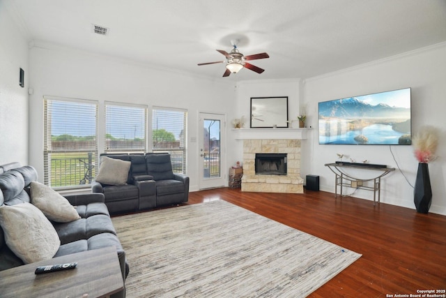 7027 Laura Hts, Schertz, TX 78154 - living room featuring crown molding, a ceiling fan, wood finished floors, plenty of natural light, and a fireplace