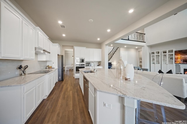 418 Sundance Way, San Antonio, TX 78253 - kitchen featuring stainless steel appliances, a sink, under cabinet range hood, open floor plan, and white cabinetry