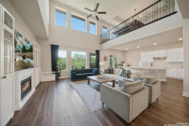 418 Sundance Way, San Antonio, TX 78253 - living area with a high ceiling, ceiling fan, plenty of natural light, a glass covered fireplace, and dark wood-style floors
