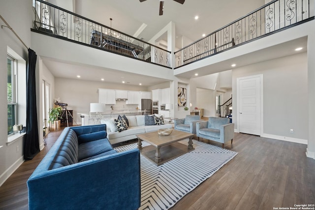 418 Sundance Way, San Antonio, TX 78253 - living area featuring a high ceiling, baseboards, stairs, dark wood-style flooring, and a ceiling fan