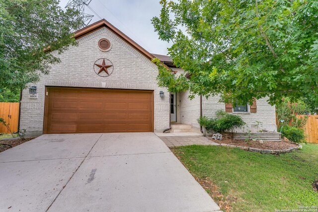 6601 Shadden Oaks, Live Oak, TX 78233 - view of front facade with concrete driveway, brick siding, and a garage