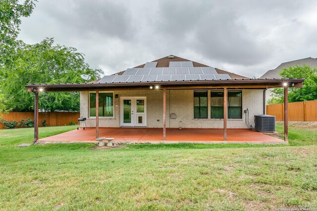 6601 Shadden Oaks, Live Oak, TX 78233 - rear view of house with brick siding, a patio, french doors, and roof mounted solar panels