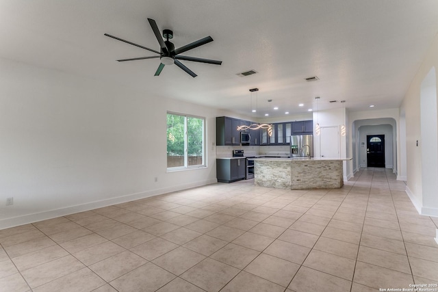 6601 Shadden Oaks, Live Oak, TX 78233 - unfurnished living room featuring arched walkways, ceiling fan, light tile patterned floors, recessed lighting, and baseboards