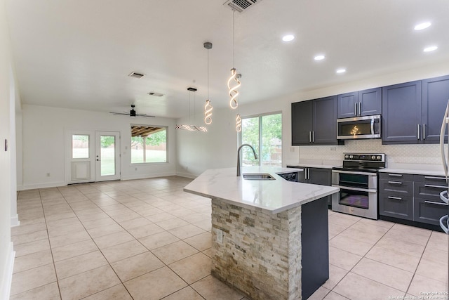 6601 Shadden Oaks, Live Oak, TX 78233 - kitchen featuring stainless steel appliances, a sink, light tile patterned floors, a ceiling fan, and recessed lighting