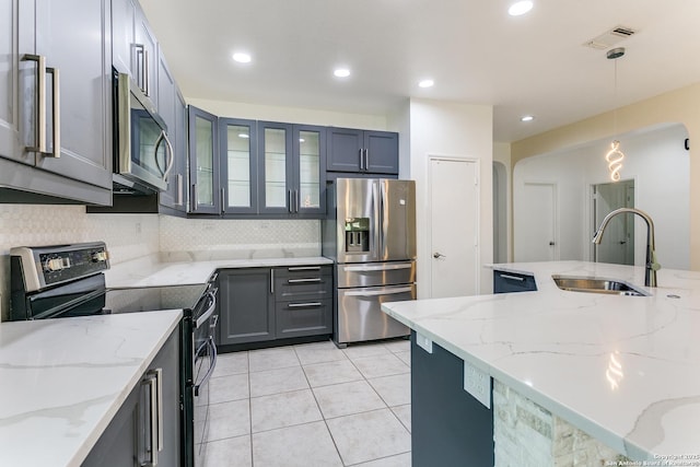 6601 Shadden Oaks, Live Oak, TX 78233 - kitchen featuring stainless steel appliances, a sink, tasteful backsplash, light tile patterned flooring, and hanging light fixtures