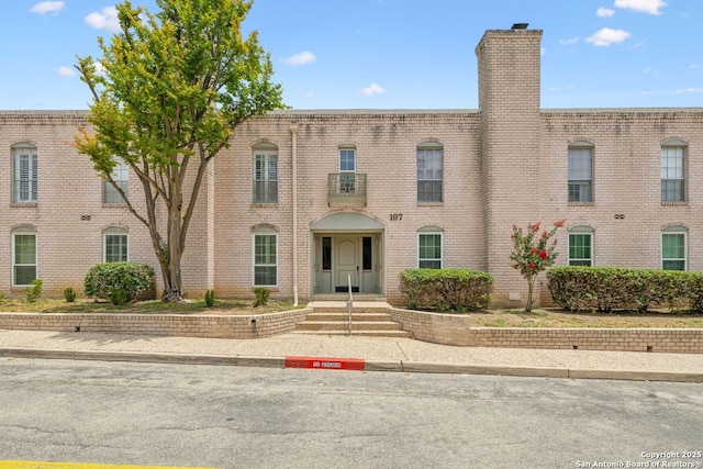 107-A Ruelle Unit 107-A, San Antonio, TX 78209 - view of front of home with brick siding and a chimney