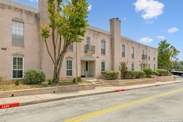 107-A Ruelle Unit 107-A, San Antonio, TX 78209 - view of front of home with a chimney and brick siding