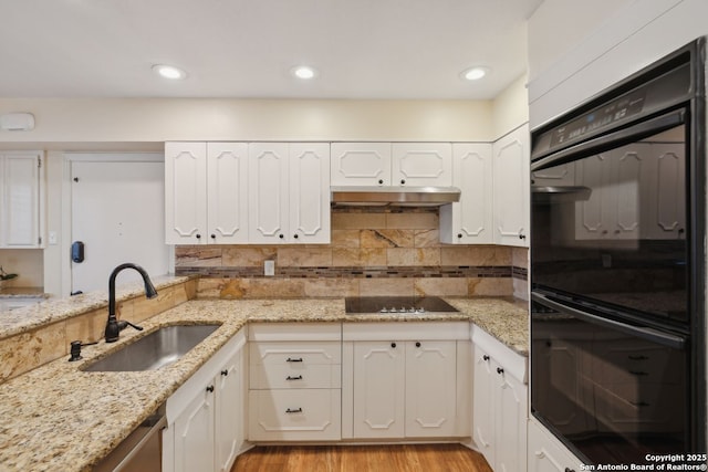 107-A Ruelle Unit 107-A, San Antonio, TX 78209 - kitchen with black appliances, a sink, white cabinets, decorative backsplash, and recessed lighting