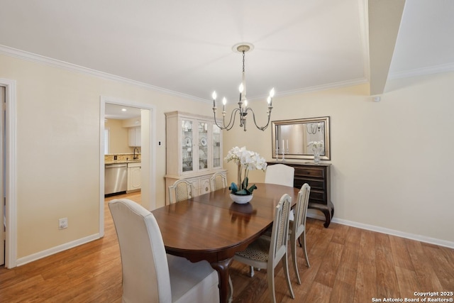 107-A Ruelle Unit 107-A, San Antonio, TX 78209 - dining space with a chandelier, ornamental molding, light wood-style floors, and baseboards