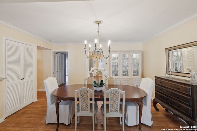 107-A Ruelle Unit 107-A, San Antonio, TX 78209 - dining space featuring a chandelier, crown molding, and wood finished floors