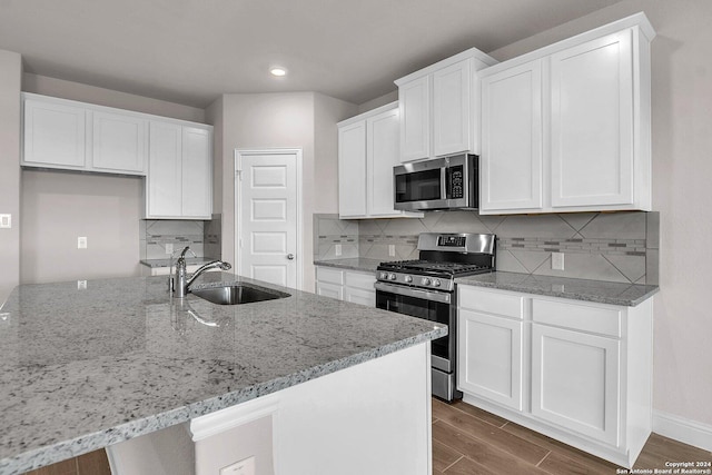 6538 Scooby Acres, San Antonio, TX 78108 - kitchen featuring stainless steel appliances, a sink, light stone countertops, white cabinets, and recessed lighting