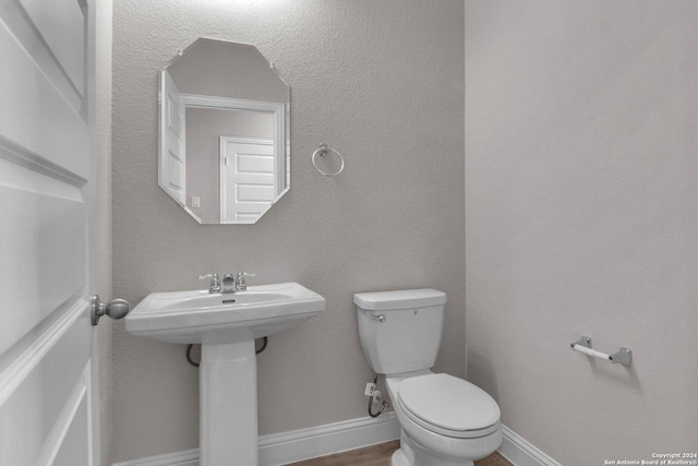 6538 Scooby Acres, San Antonio, TX 78108 - half bath with toilet, baseboards, and a sink