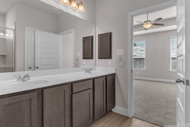 6538 Scooby Acres, San Antonio, TX 78108 - bathroom featuring double vanity, baseboards, an enclosed shower, and a ceiling fan
