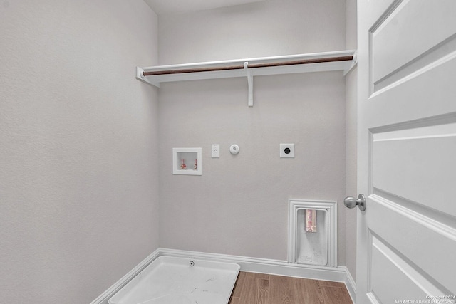6538 Scooby Acres, San Antonio, TX 78108 - laundry room with hookup for a gas dryer, electric dryer hookup, washer hookup, wood finished floors, and baseboards