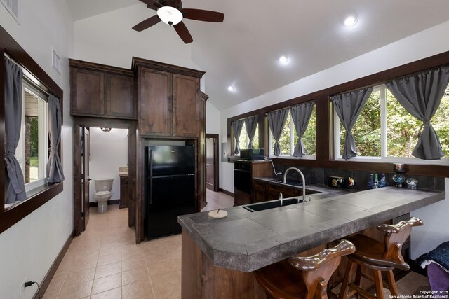 123 Serene Creek Ln, Mcqueeney, TX 78123 - kitchen featuring black appliances, a sink, tile countertops, ceiling fan, and healthy amount of natural light