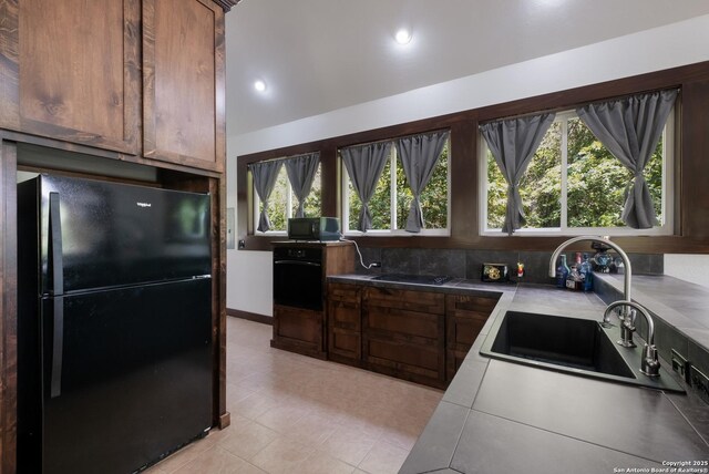123 Serene Creek Ln, Mcqueeney, TX 78123 - kitchen with black appliances, a sink, light tile patterned floors, recessed lighting, and tasteful backsplash