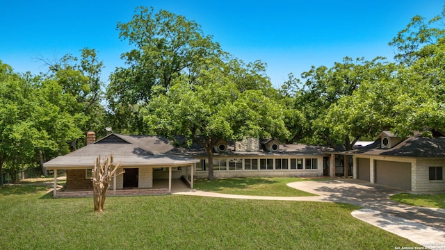 123 Serene Creek Ln, Mcqueeney, TX 78123 - rear view of property with a garage, a yard, a chimney, and concrete driveway