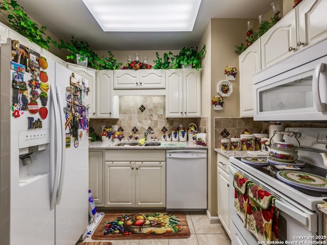1 Towers Park Unit 1813, San Antonio, TX 78209 - kitchen with white appliances, a sink, decorative backsplash, white cabinetry, and light tile patterned flooring