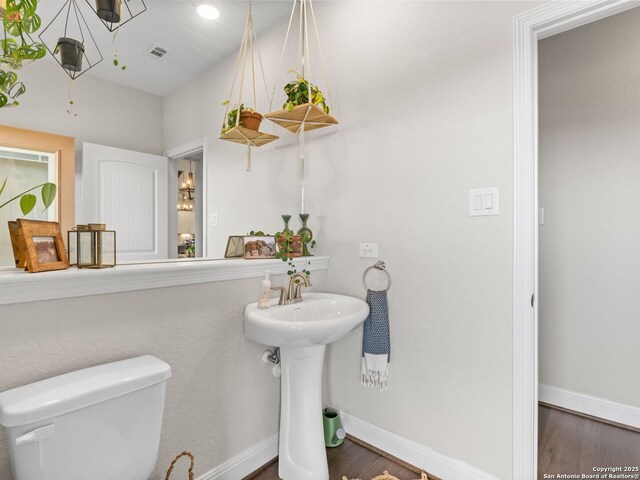 4508 River Rock, Marion, TX 78124 - half bath featuring toilet, wood finished floors, baseboards, and a sink