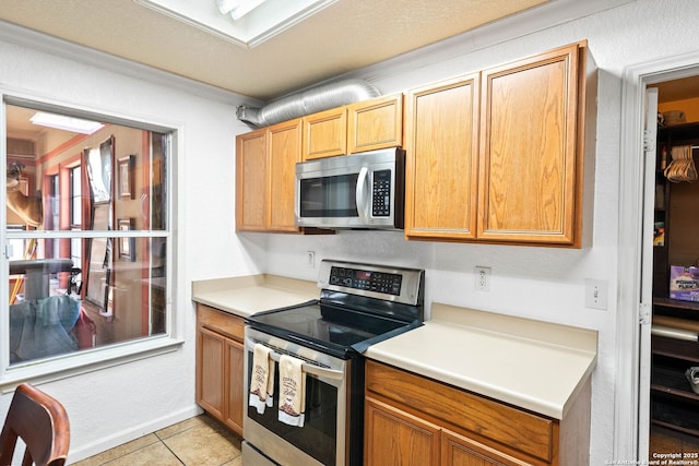 9014 Camino Rey, San Antonio, TX 78245 - kitchen with appliances with stainless steel finishes, light countertops, and light tile patterned floors