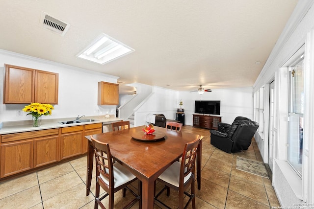 9014 Camino Rey, San Antonio, TX 78245 - dining room with a ceiling fan, stairs, light tile patterned floors, healthy amount of natural light, and crown molding