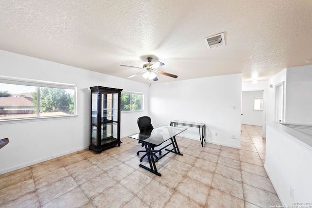 9014 Camino Rey, San Antonio, TX 78245 - living area featuring ceiling fan, a textured ceiling, plenty of natural light, and baseboards