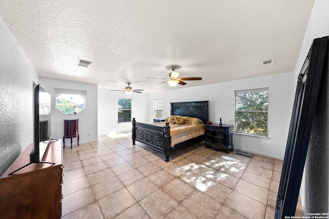 9014 Camino Rey, San Antonio, TX 78245 - bedroom featuring multiple windows, light tile patterned floors, a textured ceiling, and a ceiling fan