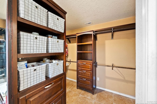 9014 Camino Rey, San Antonio, TX 78245 - walk in closet featuring light tile patterned floors